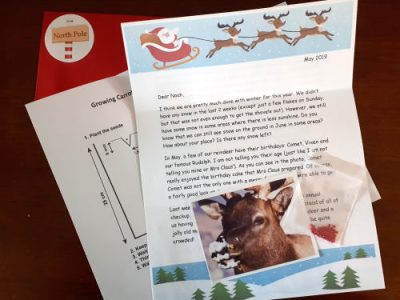 Sample Santa letter, North Pole photo, and literacy activity included in monthly mailing